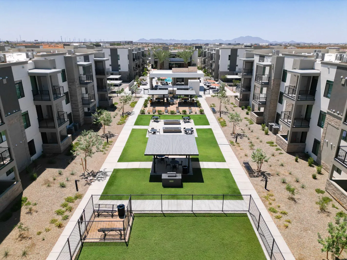 Aerial view of courtyard with lawn and shaded seating at Harmony at Hawes Crossing