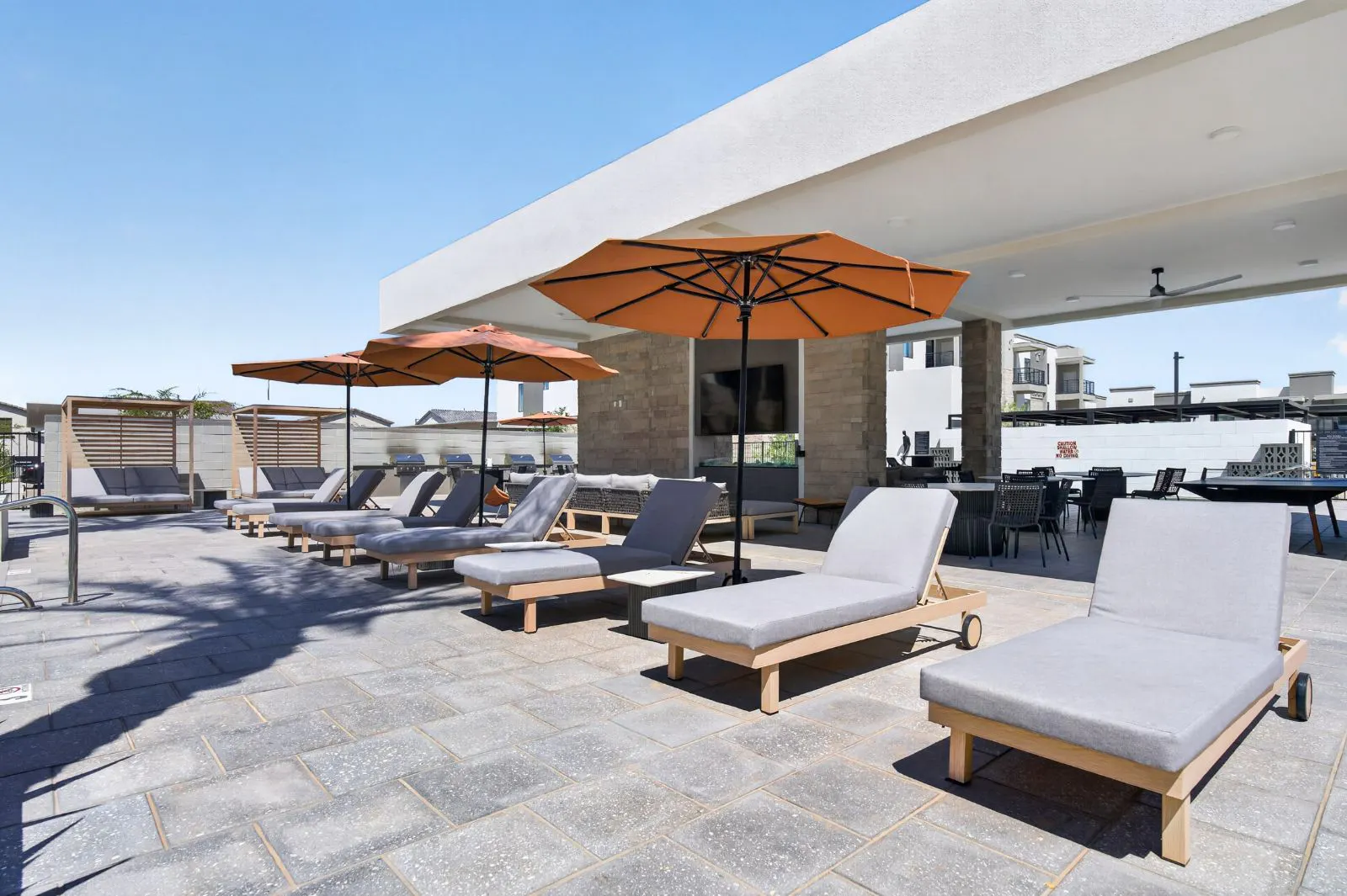 Poolside lounge chairs and shaded cabanas at Harmony at Hawes Crossing