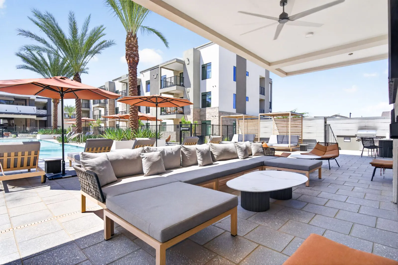 Covered poolside lounge with sectional seating at Harmony at Hawes Crossing