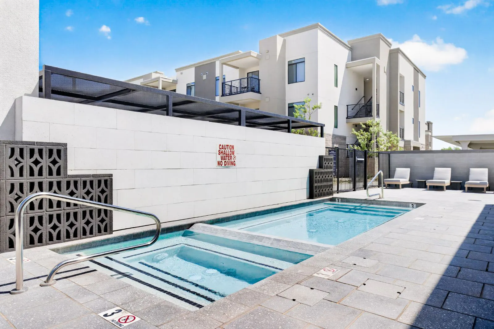 Hot tub and plunge pool with lounge chairs at Harmony at Hawes Crossing