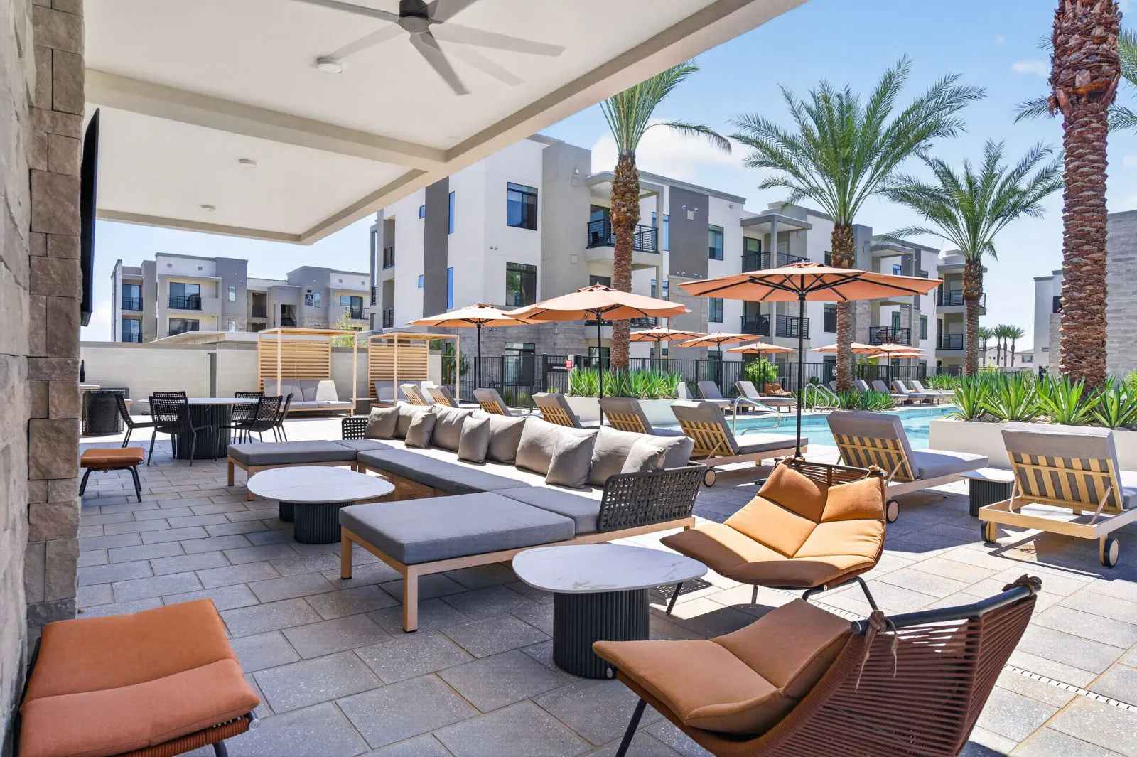 Covered lounge seating beside the pool at Harmony at Hawes Crossing