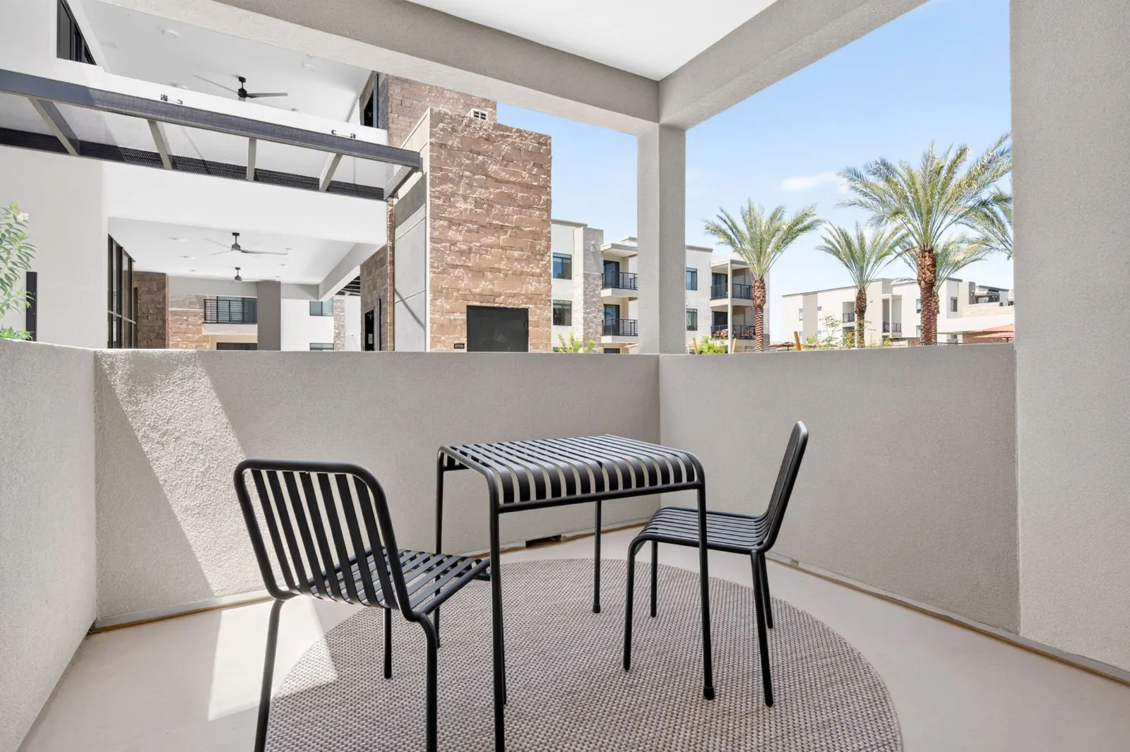 Private patio with bistro table and two chairs at Harmony at Hawes Crossing