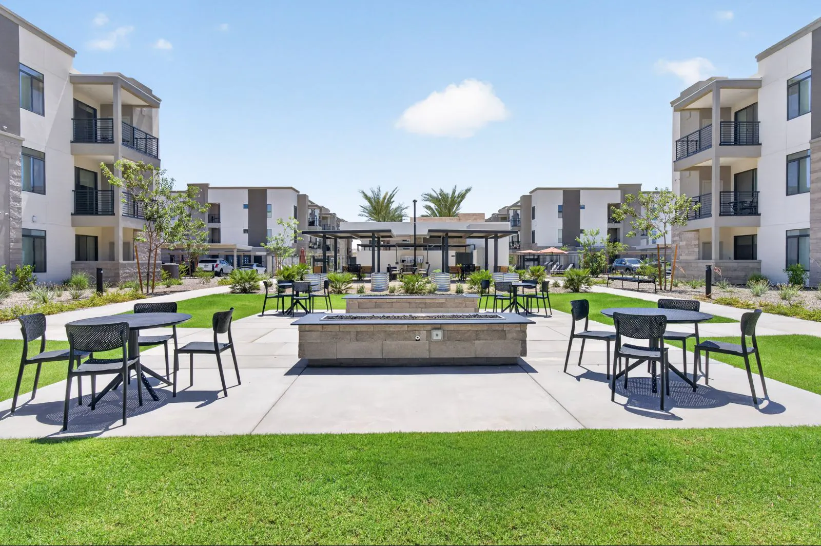 Courtyard with fire pit, lawn and patio seating at Harmony at Hawes Crossing