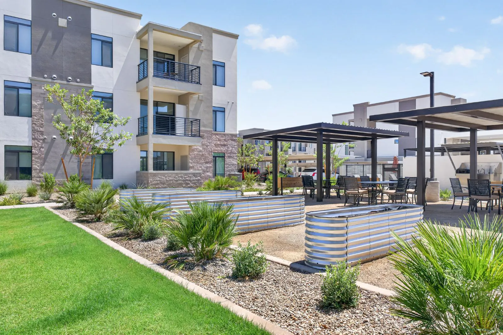 Community garden beds and shaded seating at Harmony at Hawes Crossing