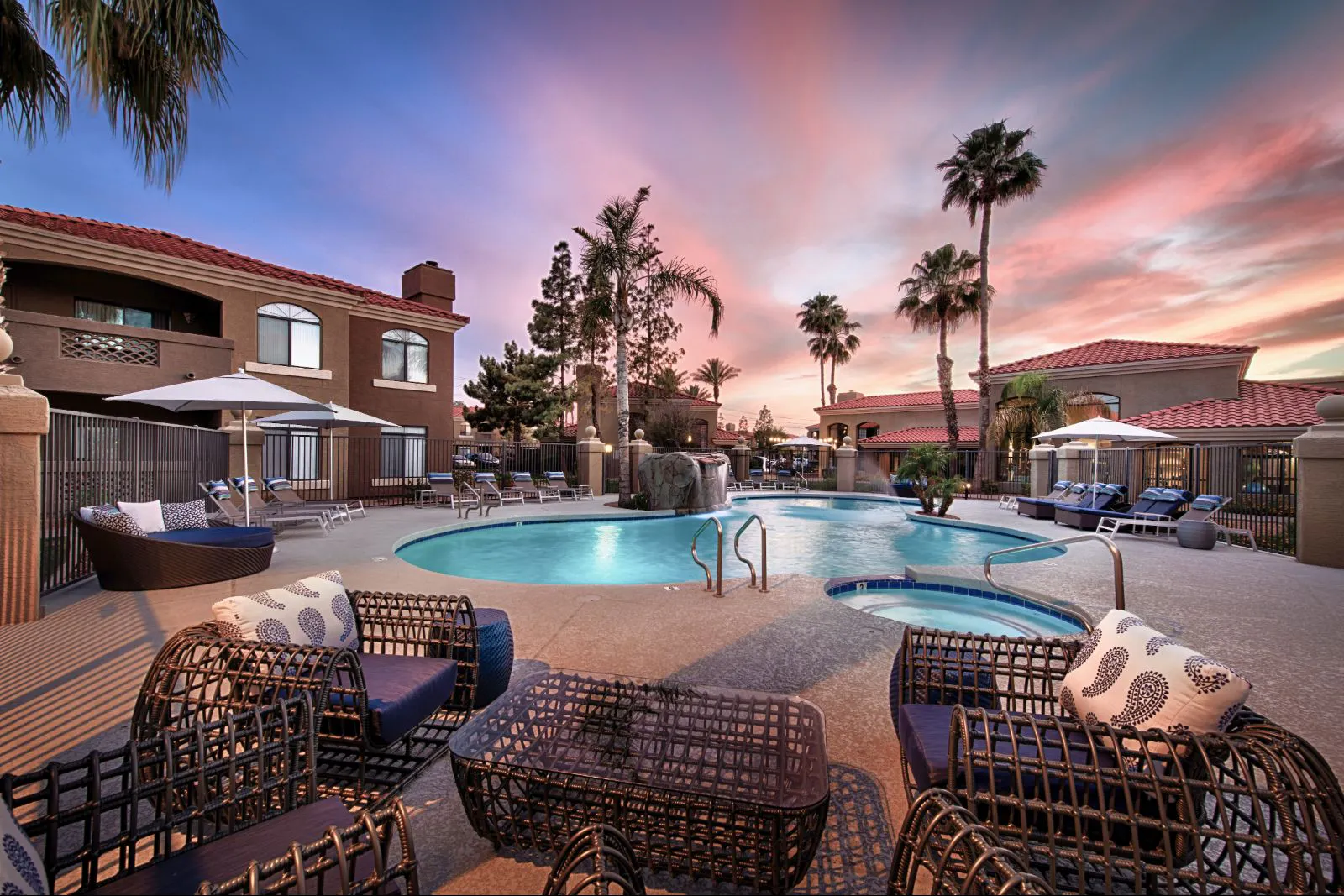 Poolside lounge seating and pool at dusk at The Ventura